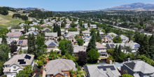 Drone view of Danville, CA rooftops with solar panels and the diablo range in the background